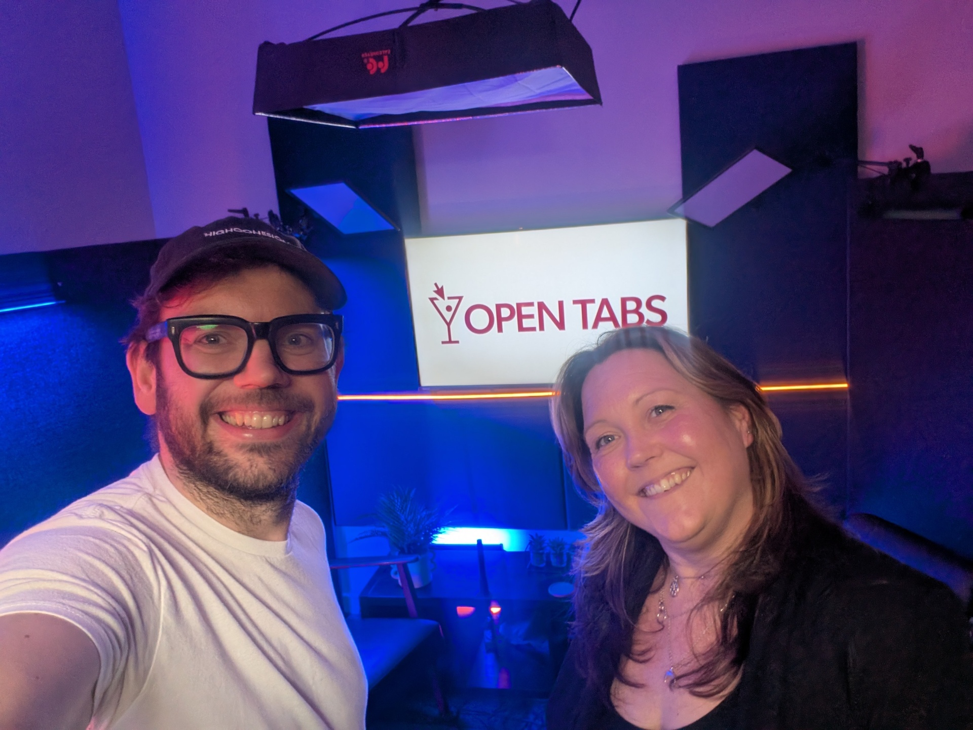 Open Tabs hosts in front of branded sign