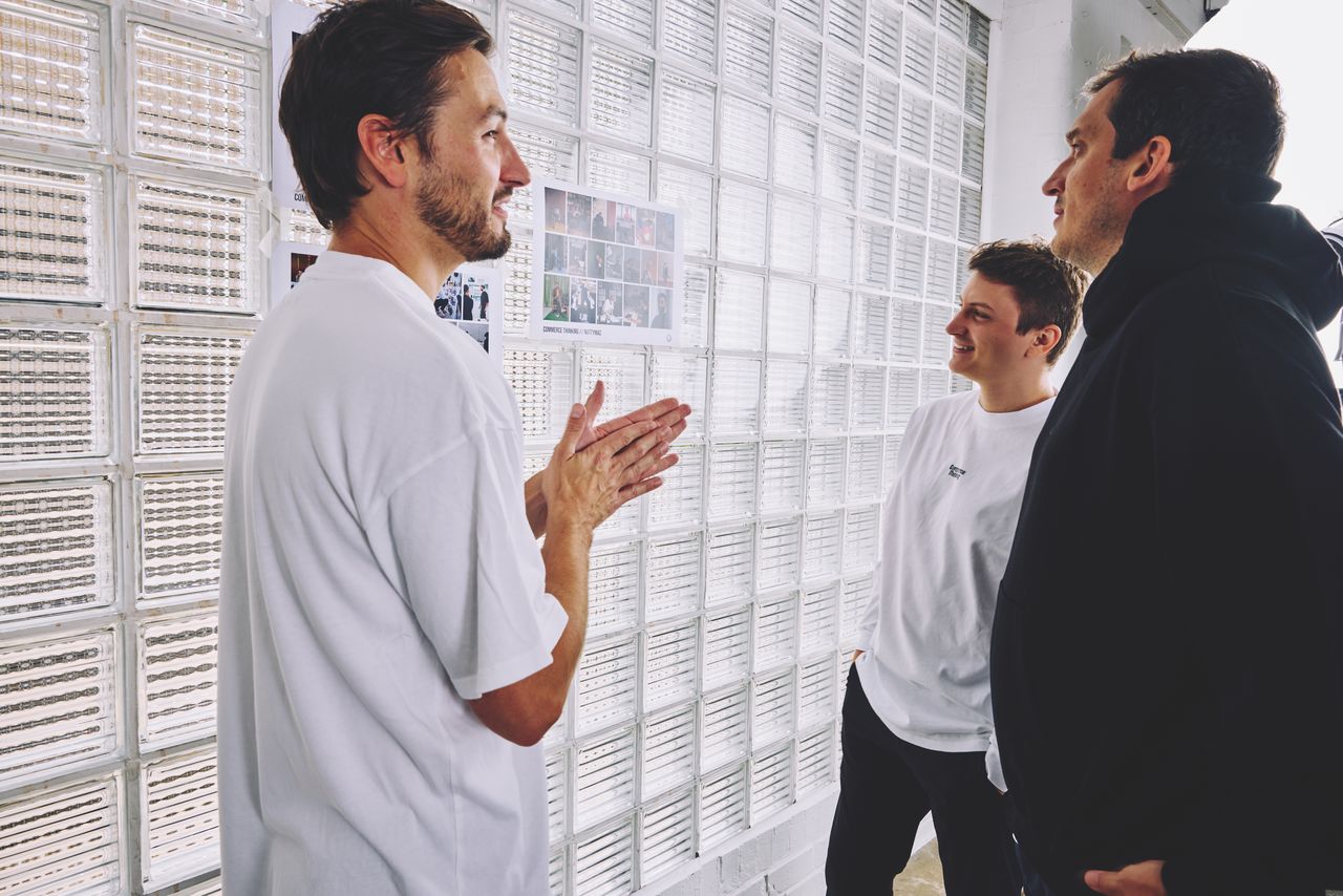 Commerce Thinking team reviewing printed editorial spreads